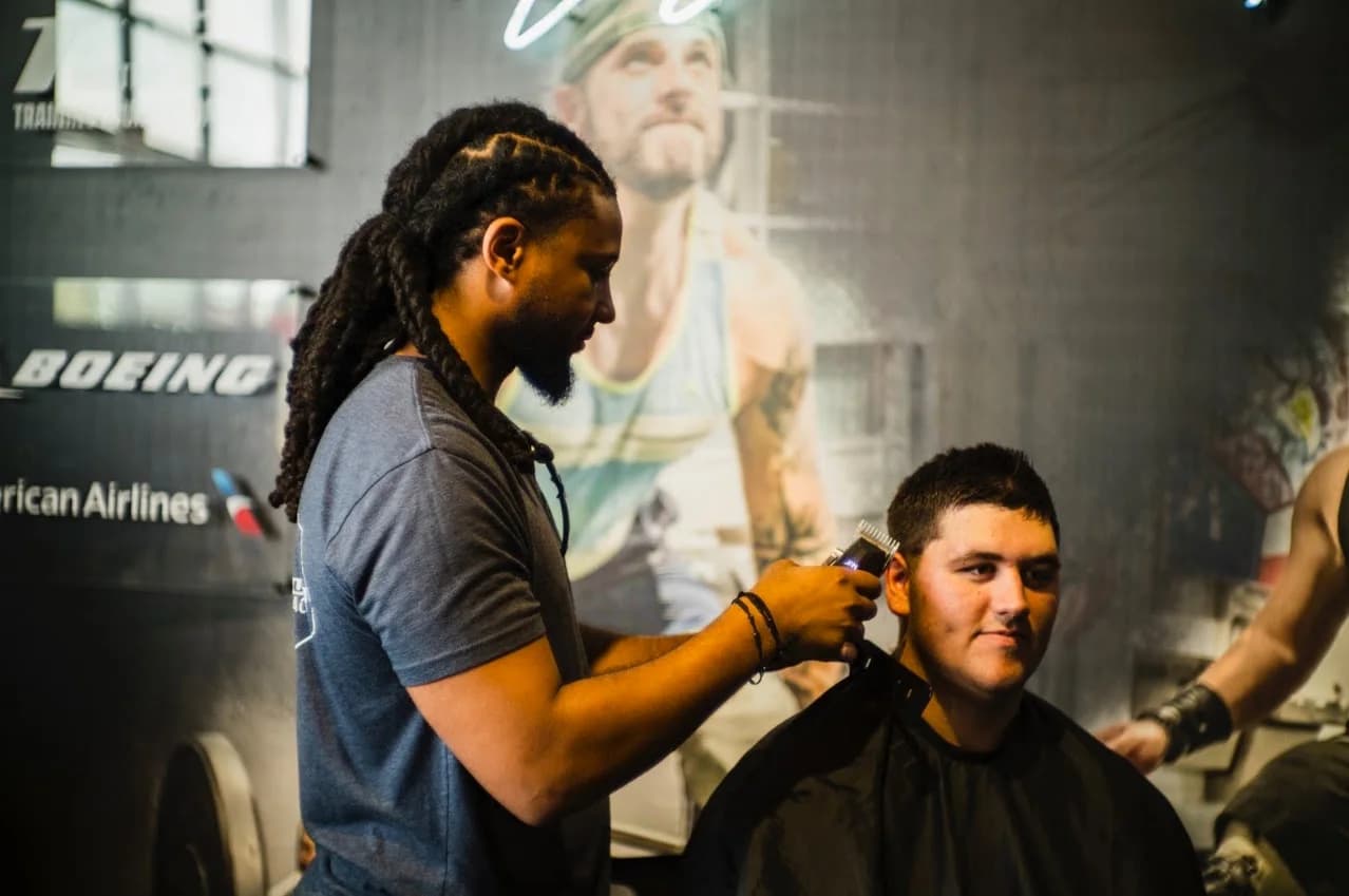 Dre shaping a client's fade with clippers
